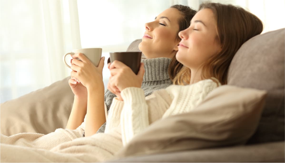 Two women enjoying heating from Terrys heating and air