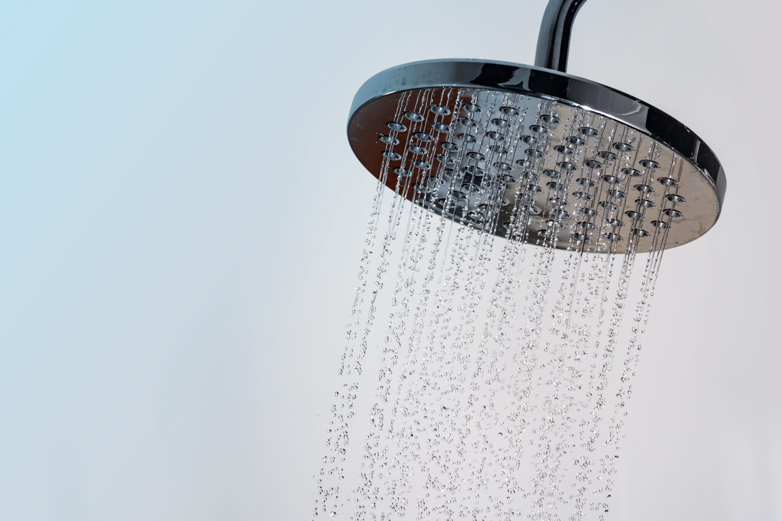 Close up of shower head with water