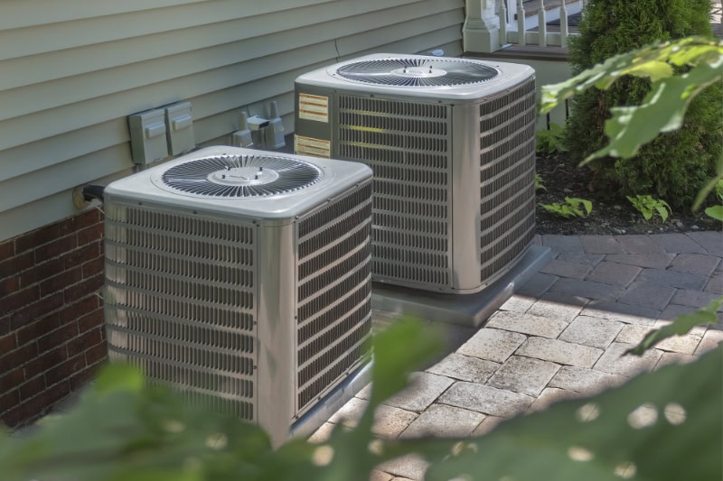 Two air conditioning units outside residential home in Twin Falls, Idaho.