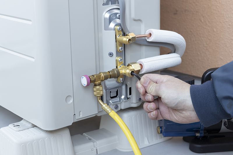 A man installing Air conditioner.