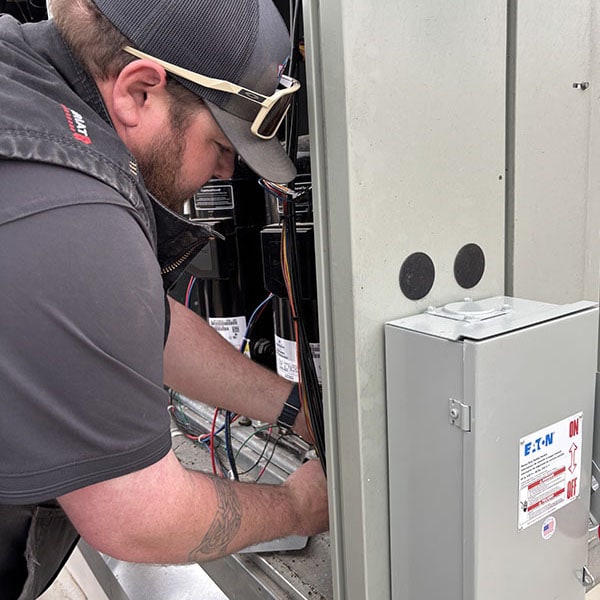 Technician installing outside equipment
