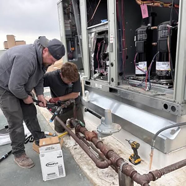 Technicians doing routine Maintenance on a unit.
