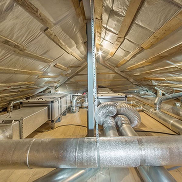 Whole house air ventilation and cleaning system. Ventilation pip Close-up of air ducts in attic space