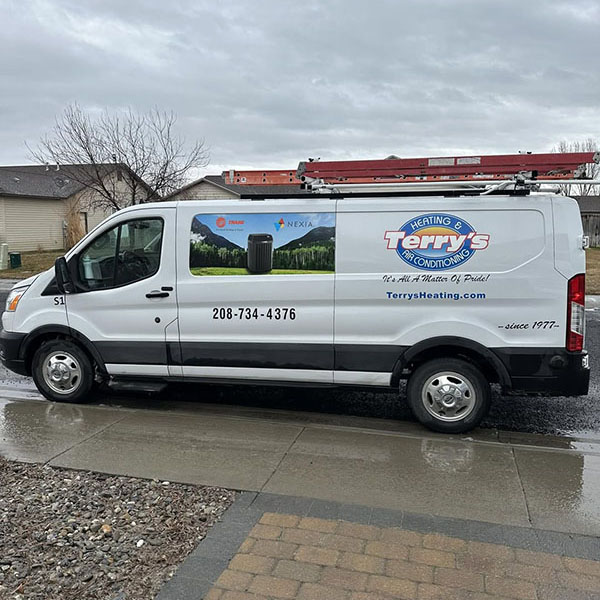 A white Ford Transit van with the logo and contact information for Terry's Heating & Air Conditioning.