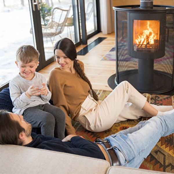 A family gathered around the floor enjoying their newly repaired fireplace