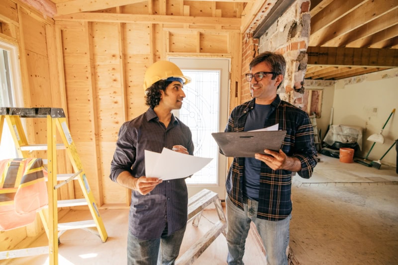 Engineer and architect reviewing details of home renovation.