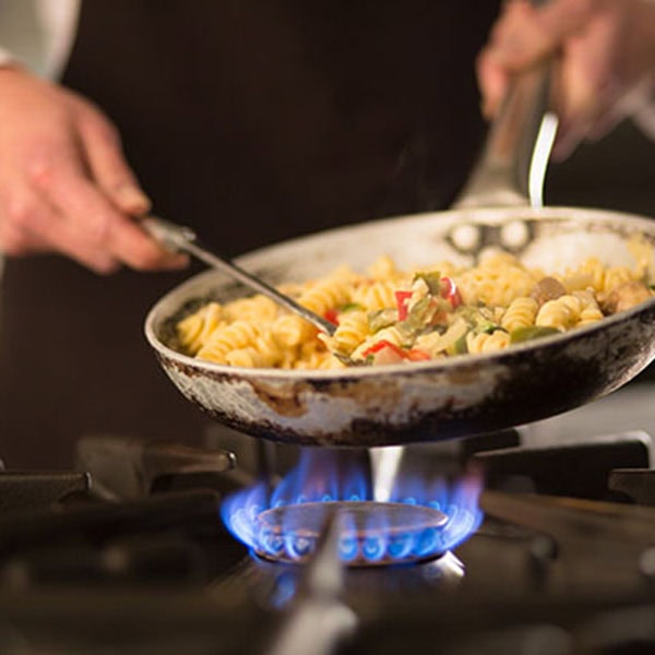 Homeowner enjoying his stove by cooking a good meal