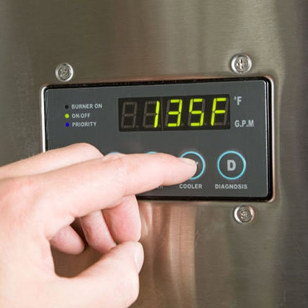 Tank Water Heaters 1_600x600 A person pressing a button on a stainless steel refrigerator, associated with Tank Water Heaters.