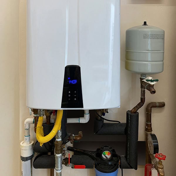 Water Heaters 1_600x600 A water heater with a pipe connection, demonstrating its role in heating water for household use.