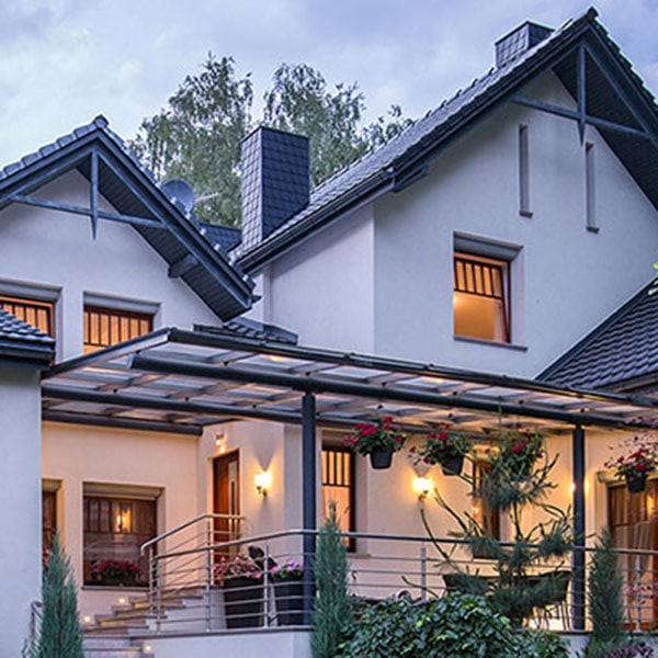 A large white house featuring a balcony, showcasing a modern design suitable for whole-house generators.