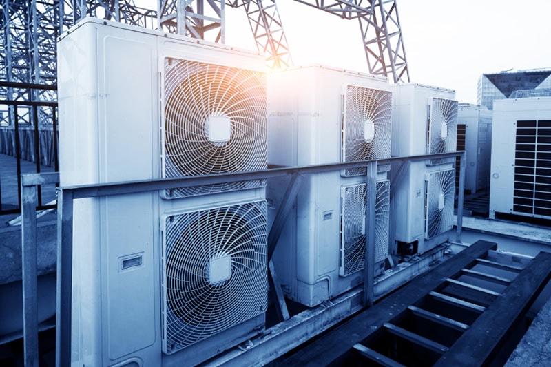 Should I Repair or Replace My Commercial Heating System? Photo of a heating system installed on top of a commercial building.